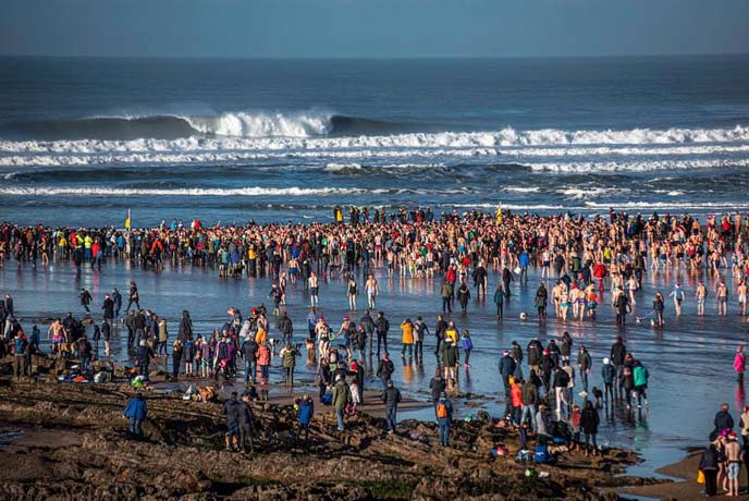 Swimmers rushing into the sea at Bude on Christmas Day