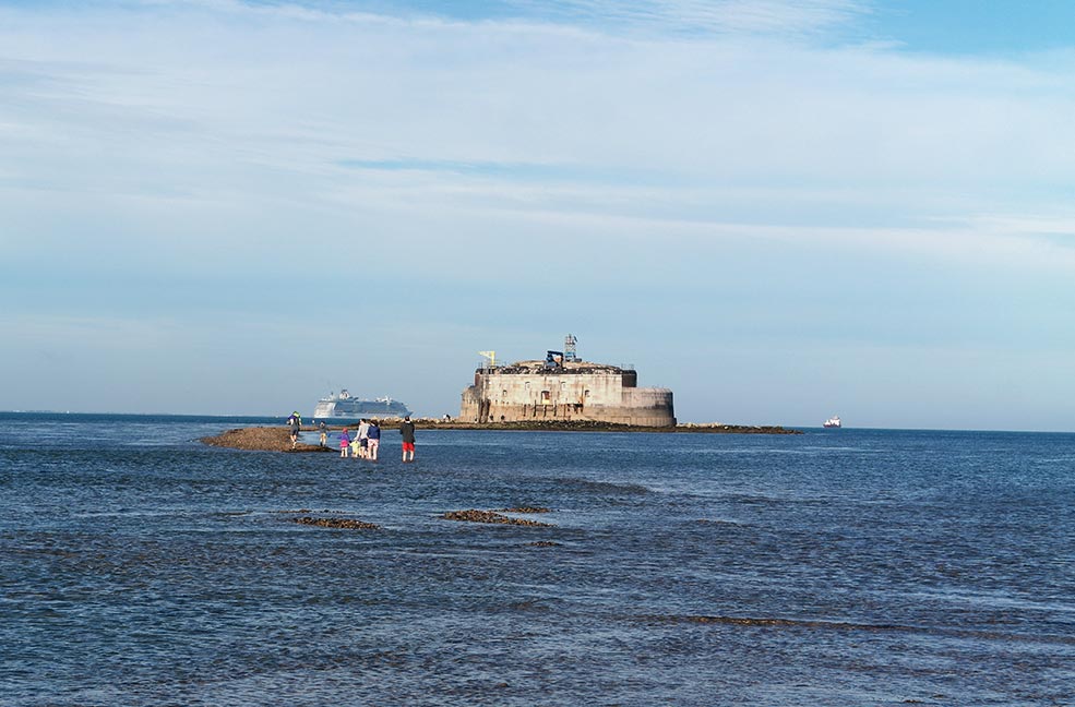 Wading through the sea to reach the fort and make it back in time before the tide comes in.