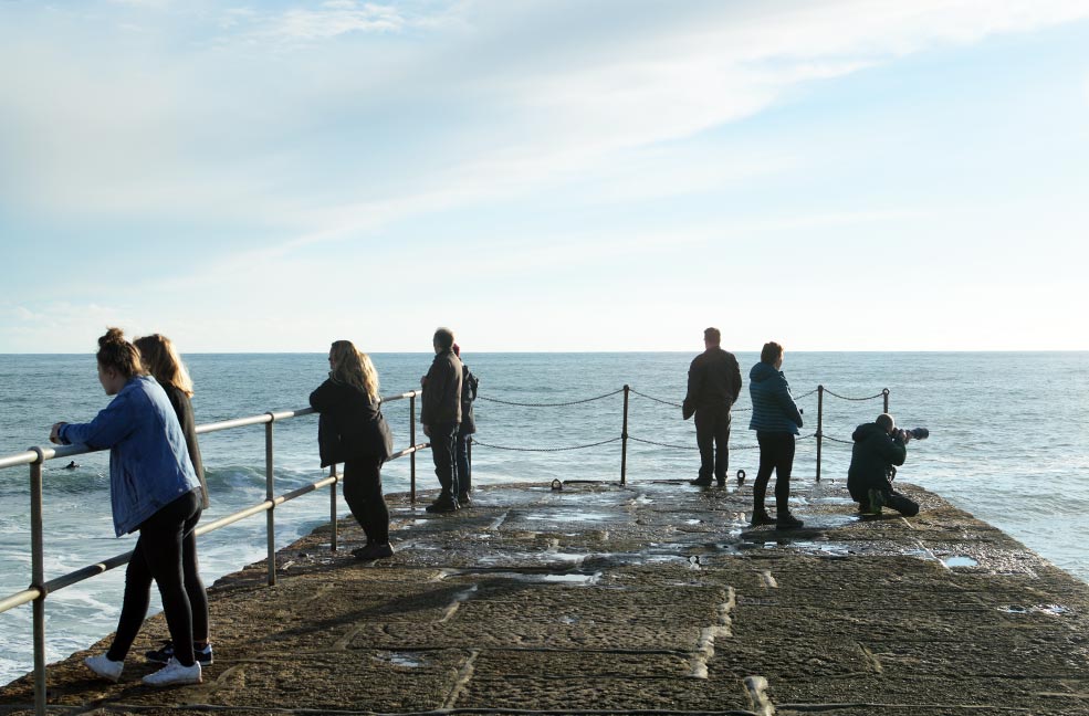 Looking out at the sea from the edge of Porthleven harbour.