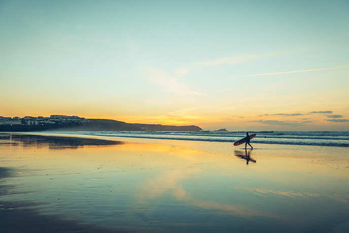 Surfing at Fistral Beach is a fun way to get in the water and get your body moving.