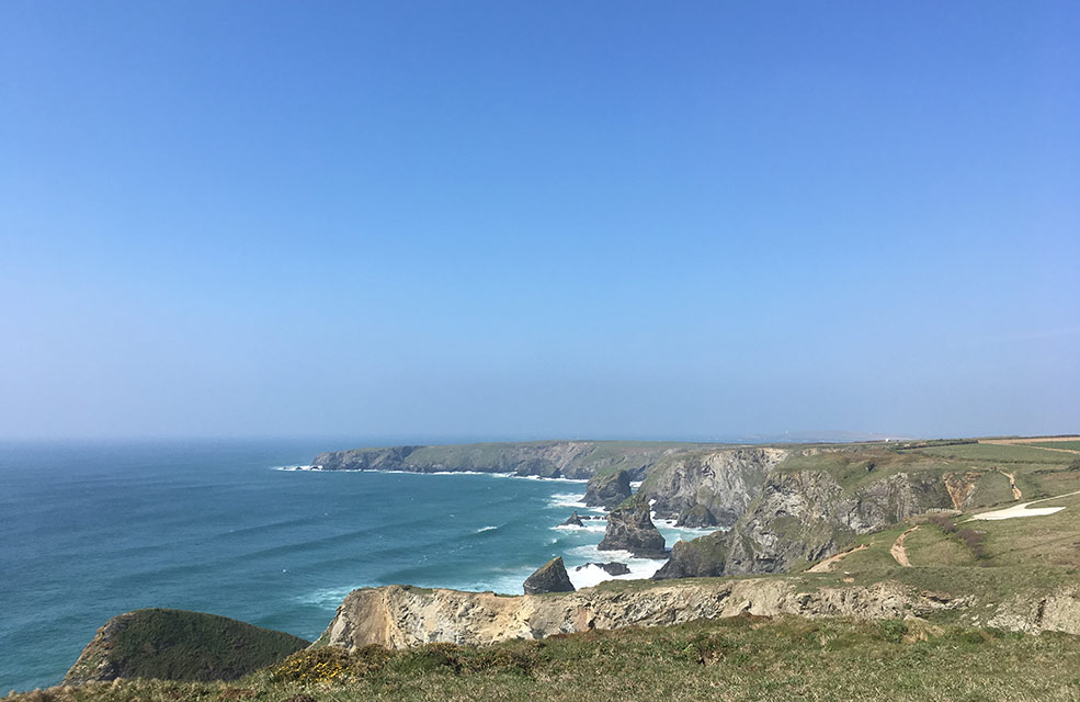 We see Bedruthan Steps in the distance from the coast path and know that we're almost halfway along our walk.