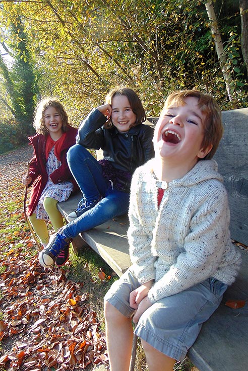 Smiles all round as we wander through the trees of our local woodland.