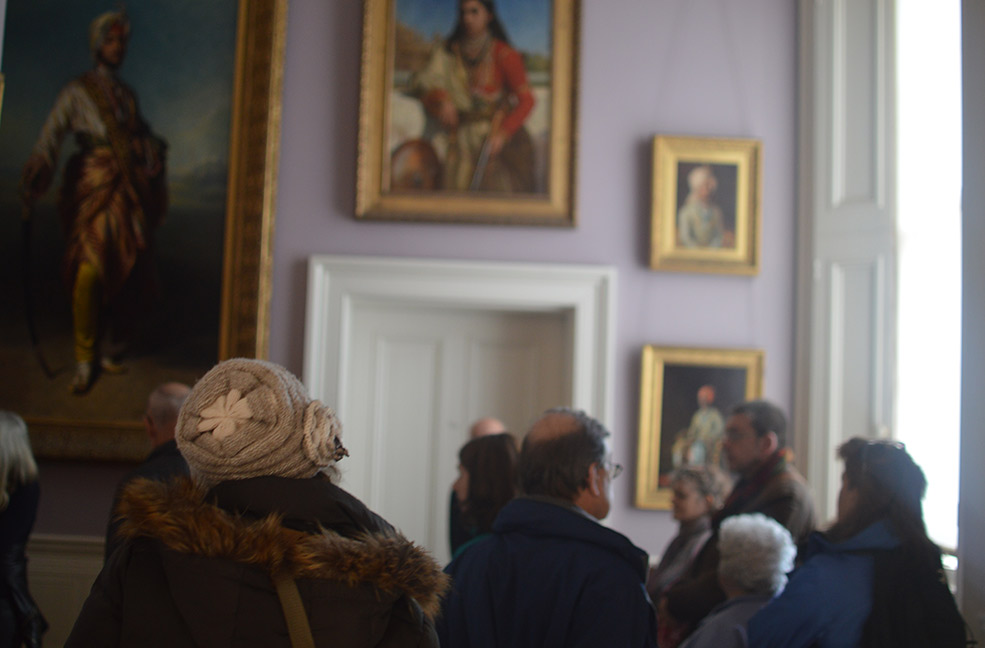 A group touring the hallways of Osborne House on the Isle of Wight