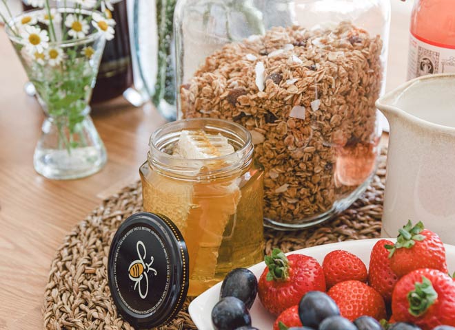 fresh honey displayed with fruit and cereal on a holiday cottage welcome tray