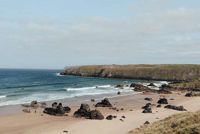 White sands, rock formations, and blue waters at Sango Bay on the NC500