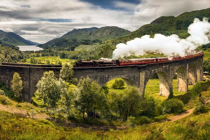 A steam train travelling along the famous Glenfinnan Viaduct in Scotland