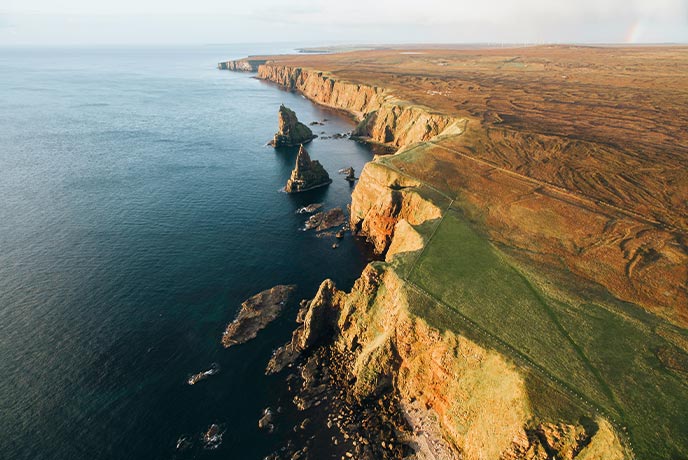 The iconic coastline and Duncansby Stacks at Duncansby Head in Scotland