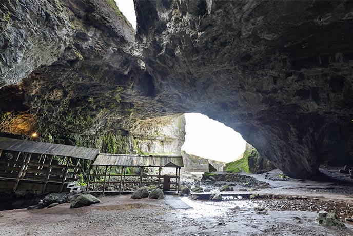 The massive rocky interior of Smoo Cave in Scotland