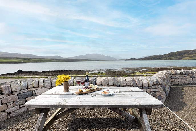 A table overlooking an estuary with mountains in the background in the Scottish Highlands