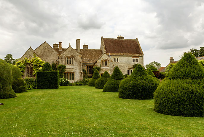 Looking up the freshly cut lawn and carefully shaped trees at Lytes Cary Manor