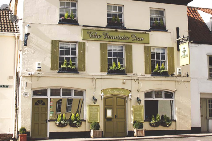 The cream exterior of The Fountain Inn in Somerset