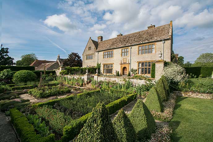 Looking up the freshly cut lawn and carefully shaped trees at Lytes Cary Manor