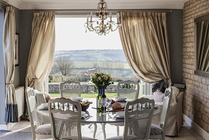 A beautiful dining table overlooking rolling countryside in Somerset