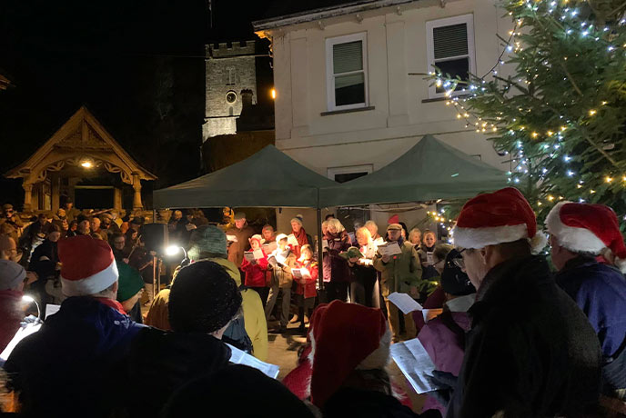 A crowd of carol singers at Dulverton by Candlelight