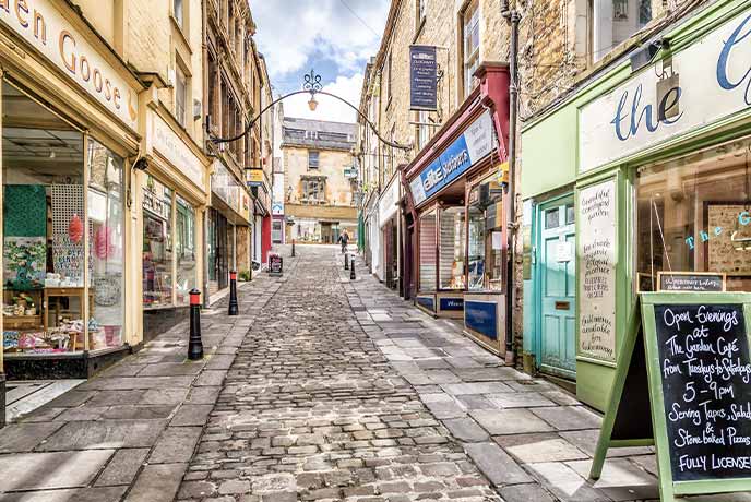 A pretty cobbled street lined with shops in Frome in Somerset