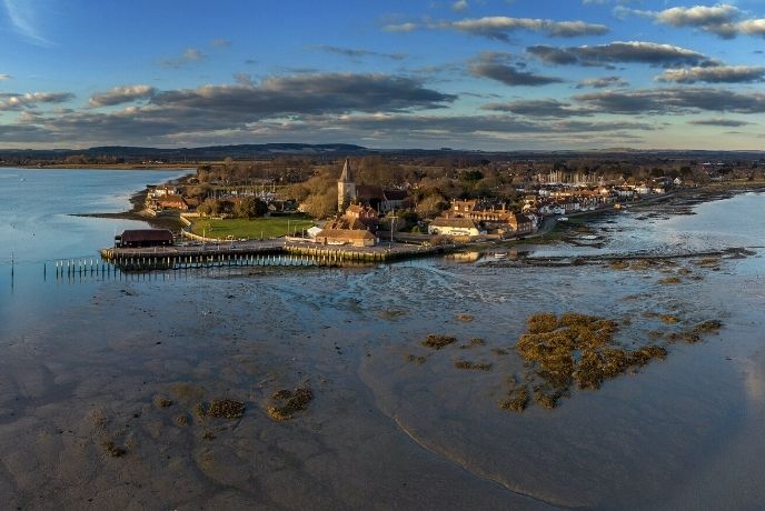 A bird's eye view of Chichester Harbour and the surrounding countryside, headland and water
