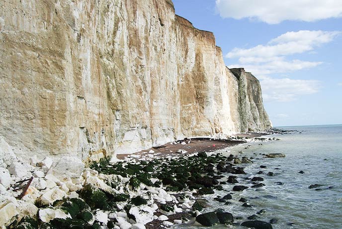 The towering white cliffs and rocky beach at Peacehaven where fossils can be found