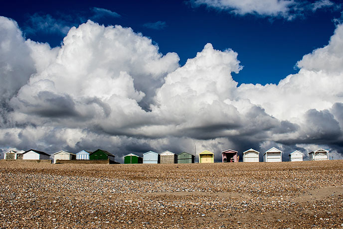 Looking up the shingle beach at Shoreham-by-Sea at the colourful beach huts