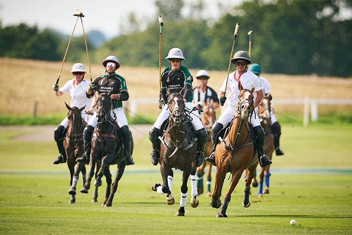 People on horseback playing a match of polo at the Cowdray Park Polo Club