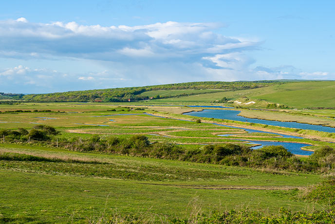 The rolling green hills around Cuckmere Valley in East Sussex