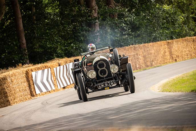 A classic car on a race track at Goodwood Festival of Speed in Sussex