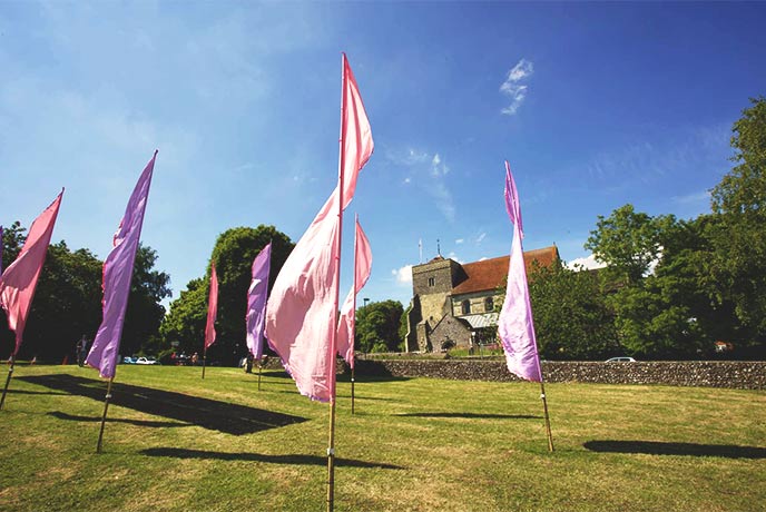 Colourful flags in a field at the Steyning Festival in Sussex