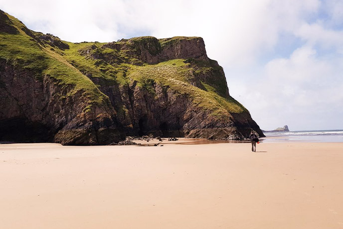 The golden sands and green cliffs at Rhossili Bay in Glamorgan