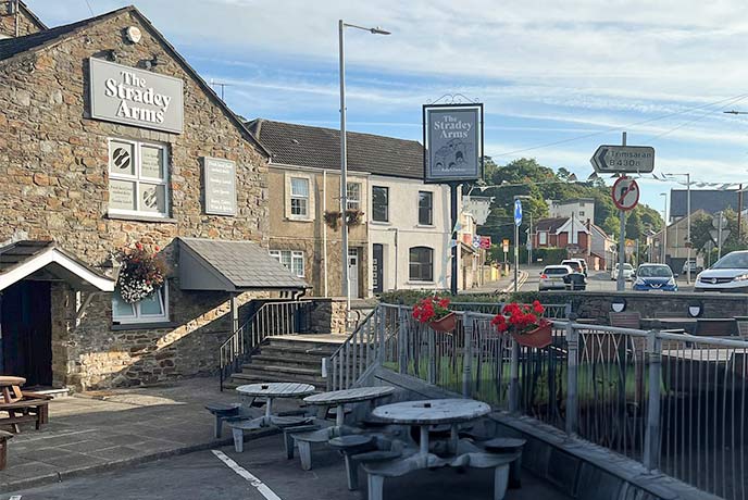 The stone exterior and outdoor seating at The Stradey Arms in Wales