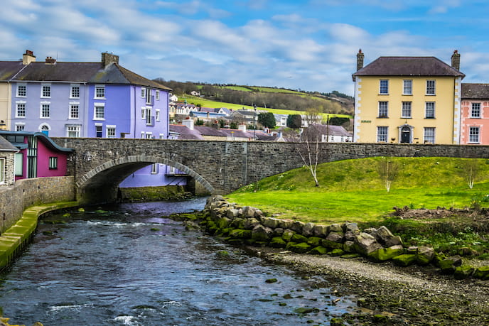 Looing up a river at a bridge and the brightly coloured houses in Aberaeron