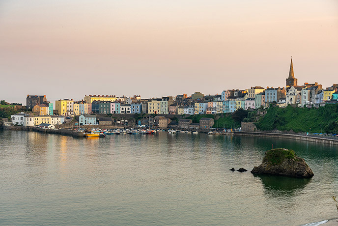 The colourful houses and pretty harbour of Tenby at sunset