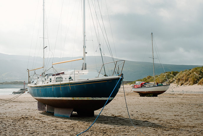 Boats on the sand at Barmouth beach in Wales