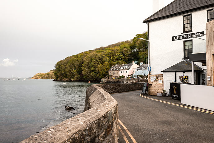 The white-painted Griffin Inn by the water in Pembrokeshire