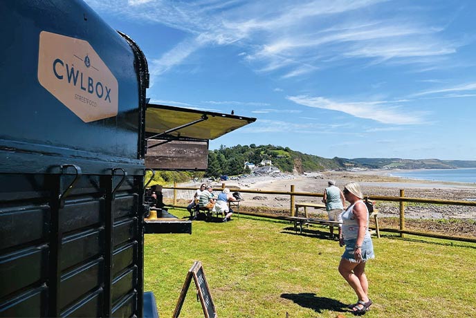 The horsebox food truck Cwlbox overlooking the beach in Pembrokeshire