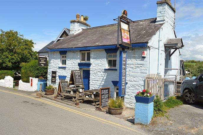 The pretty blue exterior of The Ferry Inn in Pembrokeshire