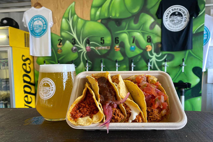 A beer and a takeaway box of tacos at Tap & Tan in Wales