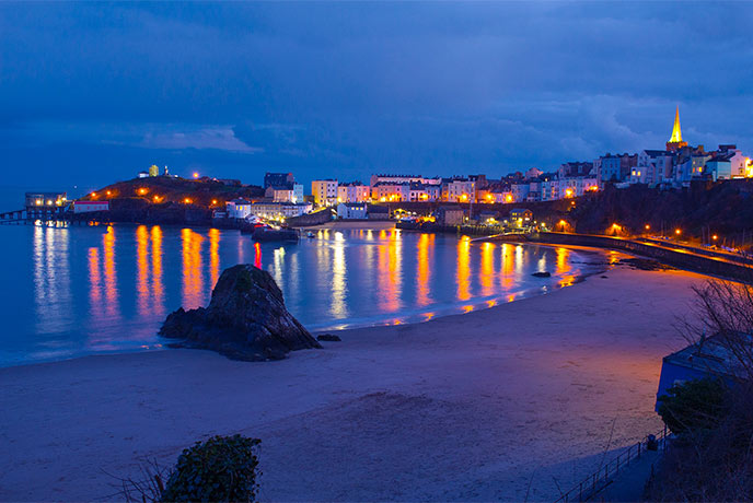 Tenby at night with lights reflecting in the harbour
