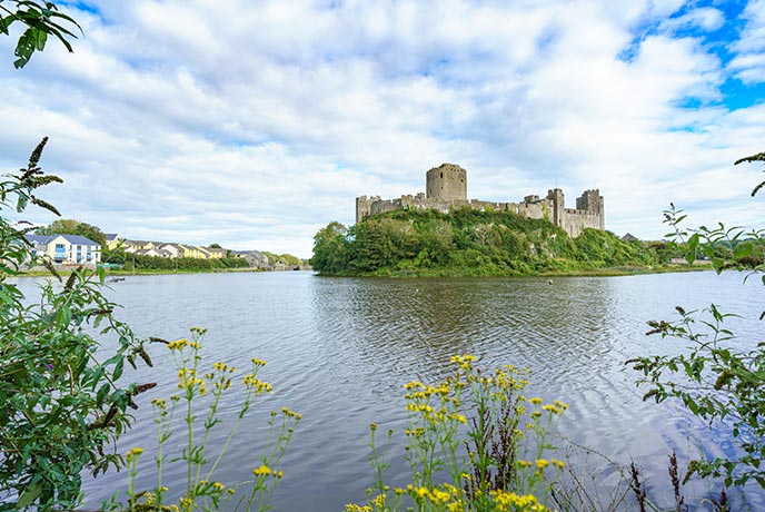 The massive Pembroke Castle in Pembrokeshire surrounded by water