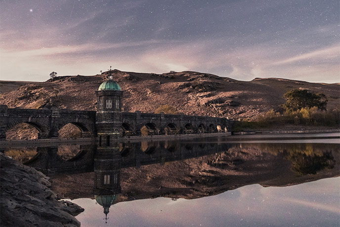A beautiful bridge with the night sky beyond at Elan Valley in Wales