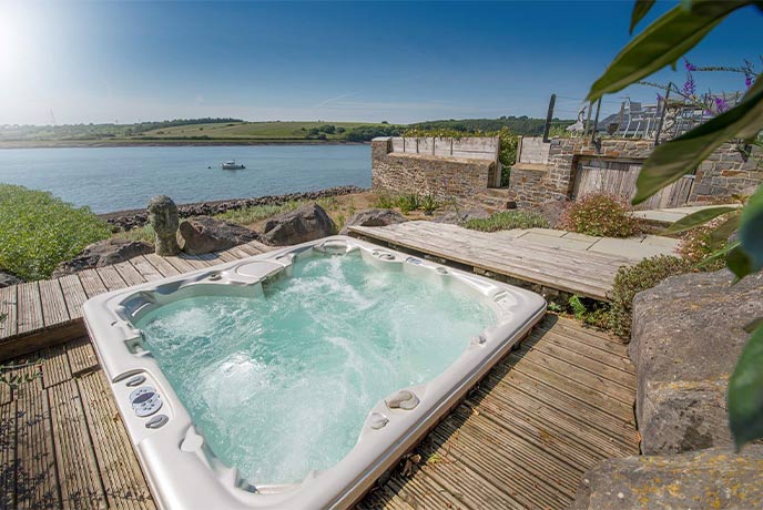 The incredible hot tub at Beach House in Pembrokeshire looking out over the estuary