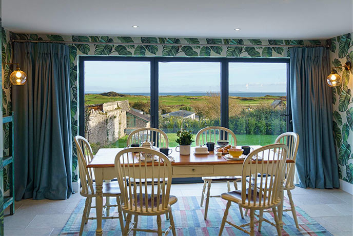 The vibrant dining room at Landsker House looking out over the countryside