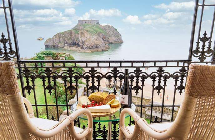 A beautiful terrace with outdoor seating overlooking the beach at St Catherine's House in Pembrokeshire