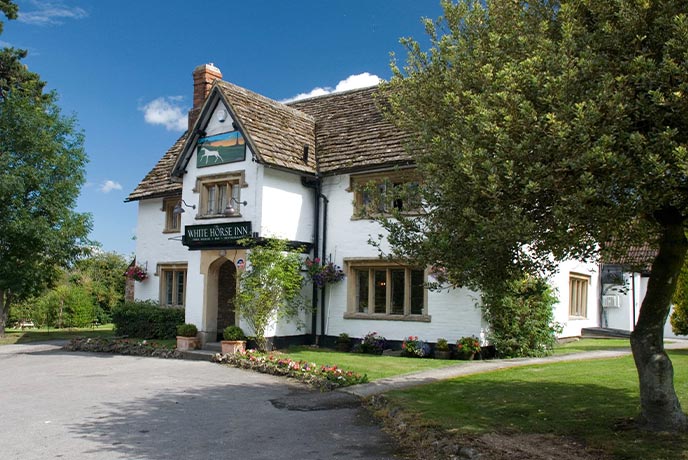 The traditional cottage exterior of The White Horse Inn in Wiltshire