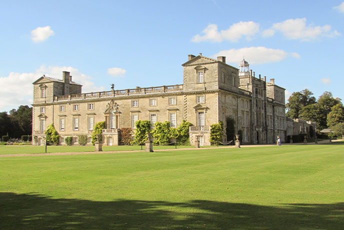 The stately exterior and green lawns at Wilton House in Wiltshire