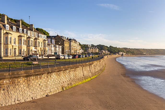 Pretty houses run alongside the golden sands of Filey Beach in Yorkshire