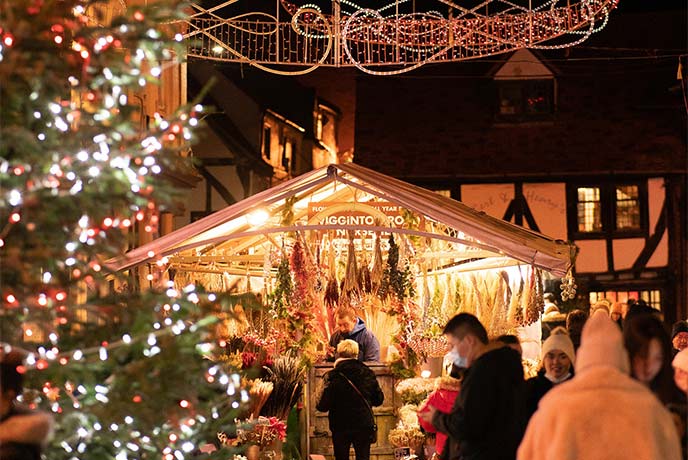 A Christmas stall lit up with Christmas lights at York Christmas Market in Yorkshire