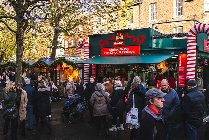 People shopping at York Christmas Market in the daytime