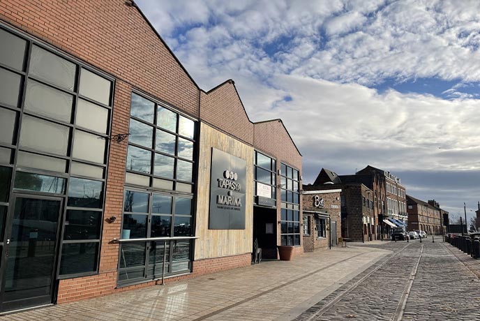 The modern exterior of Tapasya Marina by the harbour in Hull