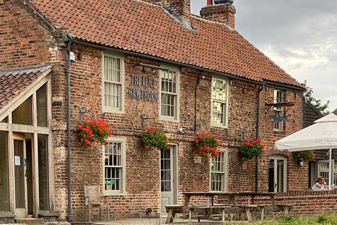 The red-brown-bricked exterior of Alice Hawthorn Inn in Yorkshire