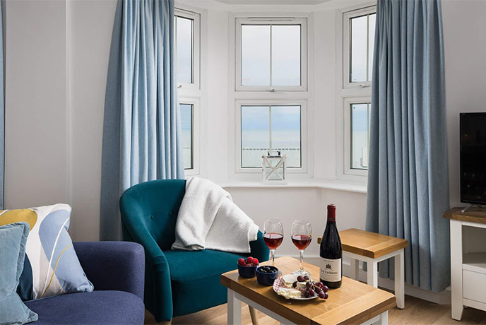 A cosy living room with sea views out of the window