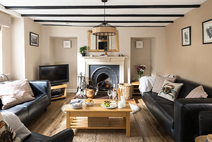 The cosy sitting room with a roaring fire at Greystones in Yorkshire